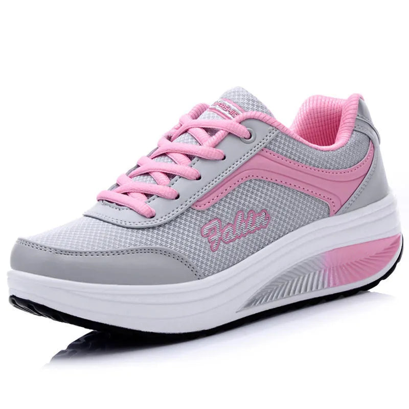 Women's grey powder mid-heel heelless travel and sports shoes on a white background.