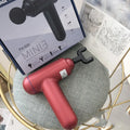 Black fascia gun massager with USB charging port for muscle relaxation therapy.