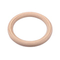 Birch wood gymnastics rings with nylon straps on a pull-up bar in a home gym setting