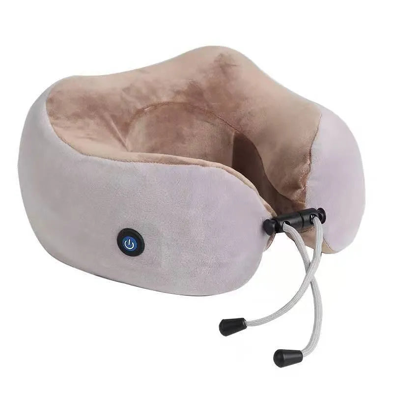 Brown U-shaped electric neck massage pillow with control buttons, shown on a table.