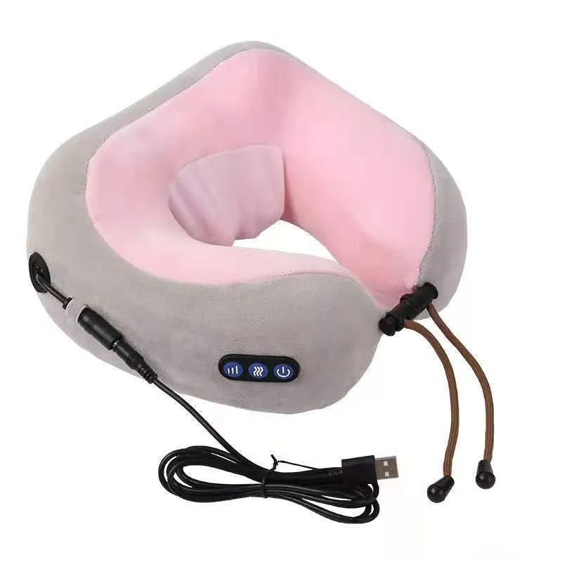 Brown U-shaped electric neck massage pillow with control buttons, shown on a table.