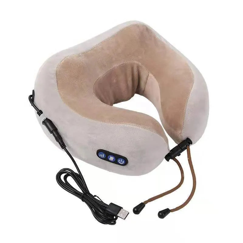 Brown U-shaped electric neck massage pillow with control buttons, shown on a table.