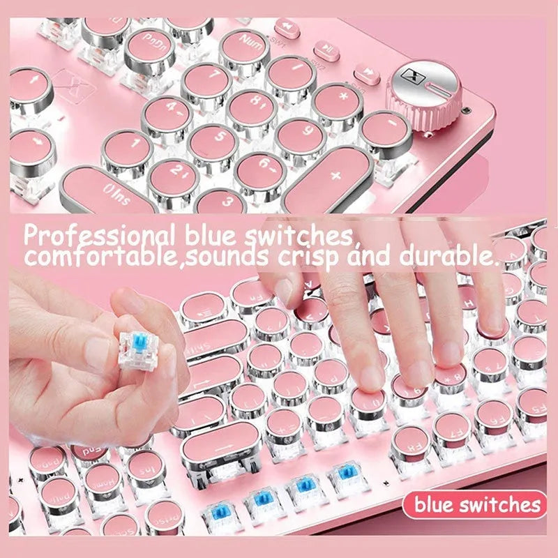Pink and silver mechanical keyboard with green switches and white backlighting, alongside a wired mouse.