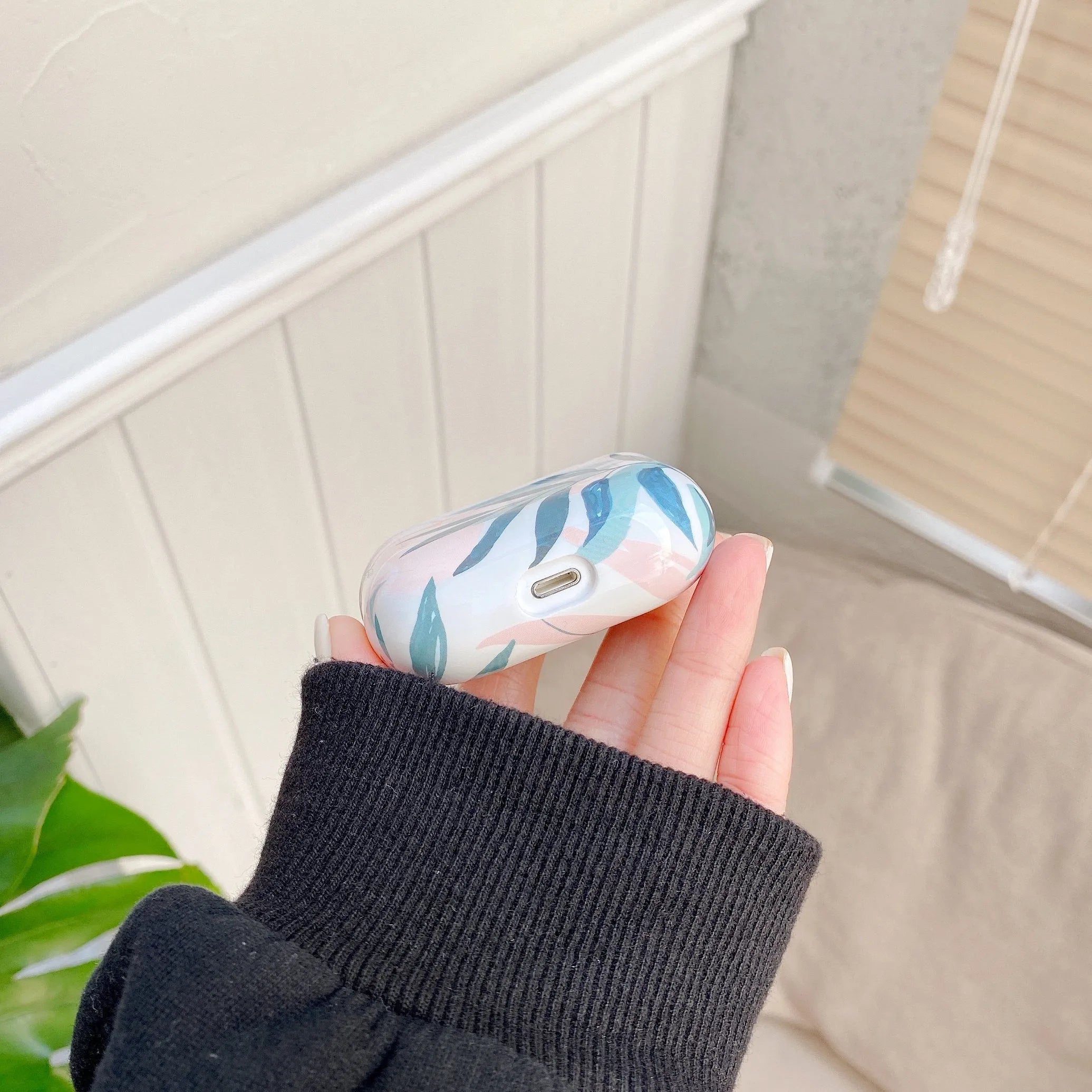 Blue TPU AirPods case with painted tropical banana leaves design