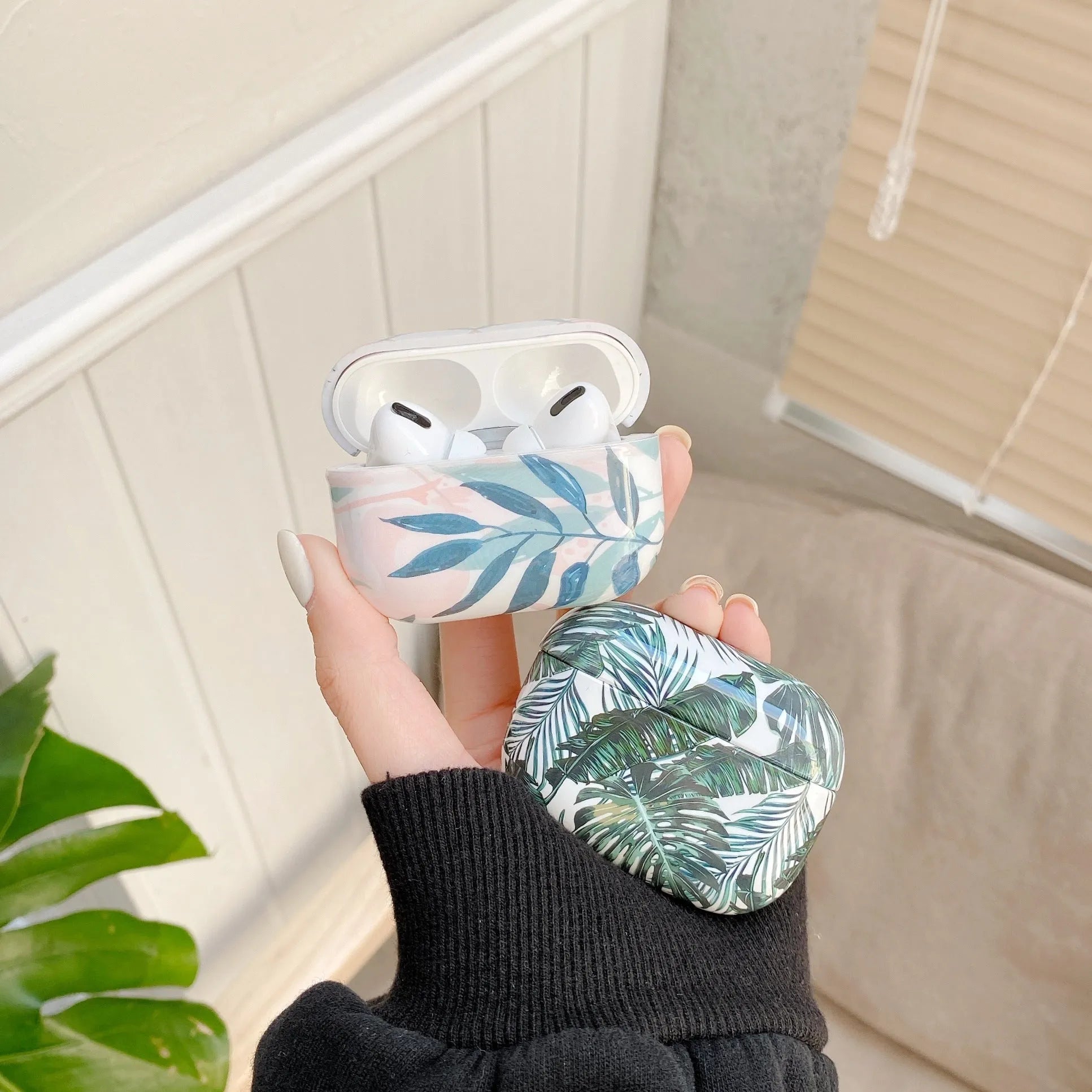 Blue TPU AirPods case with painted tropical banana leaves design