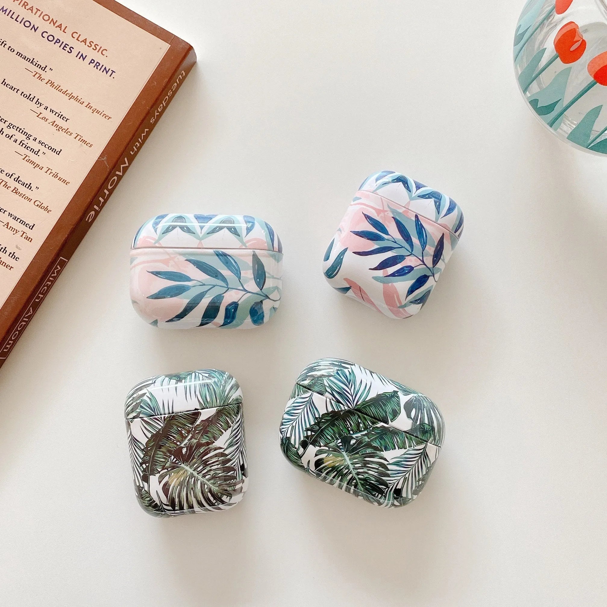 Blue TPU AirPods case with painted tropical banana leaves design