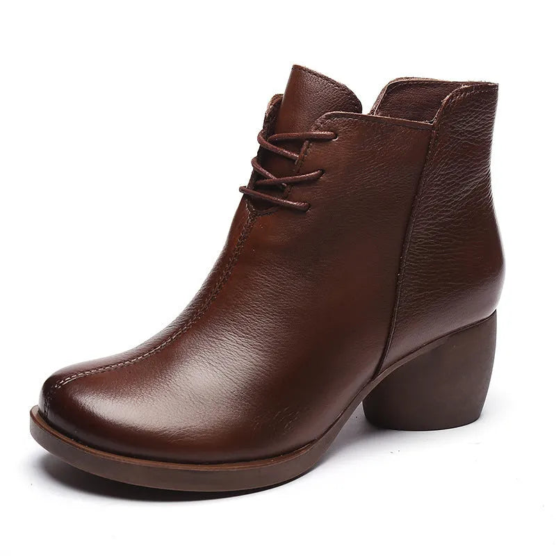 Brown women's leather Martin boots with a thick heel and round toe on a white background.