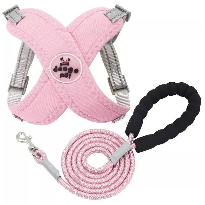 A pink dog vest harness connected to a matching hand-holding lead on a white background.