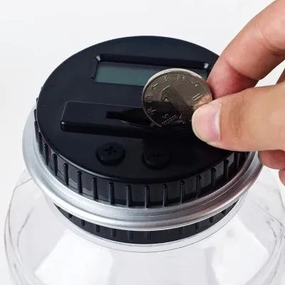 Transparent digital coin counting money box with LCD screen on black lid, 11.5cm by 20cm