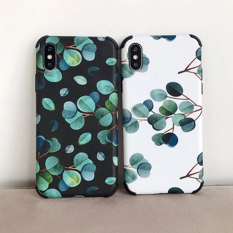 Black silicone iPhone case with a leaf pattern design on a table.