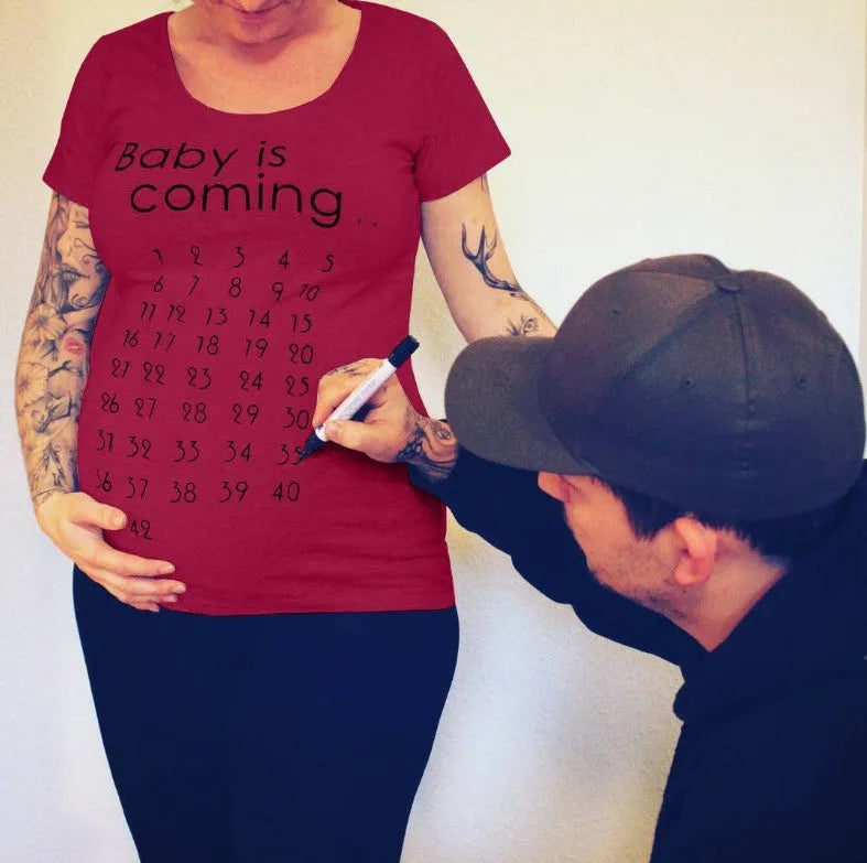 White cotton maternity t-shirt with hand print pattern, round collar, short sleeves on model