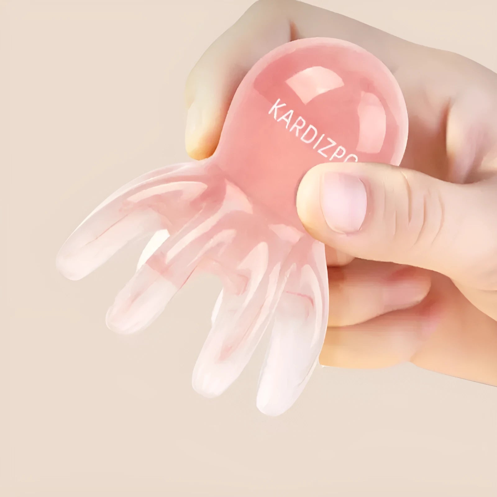Pink natural resin octopus-shaped massage comb for facial and body meridian therapy.