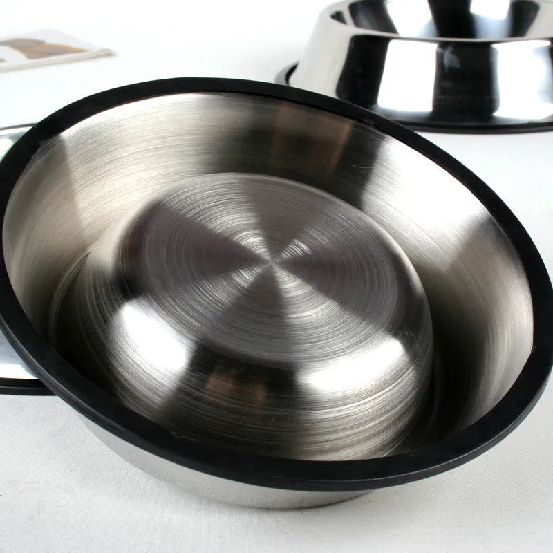 Classic stainless steel pet bowl with non-slip rubber base on a tiled floor