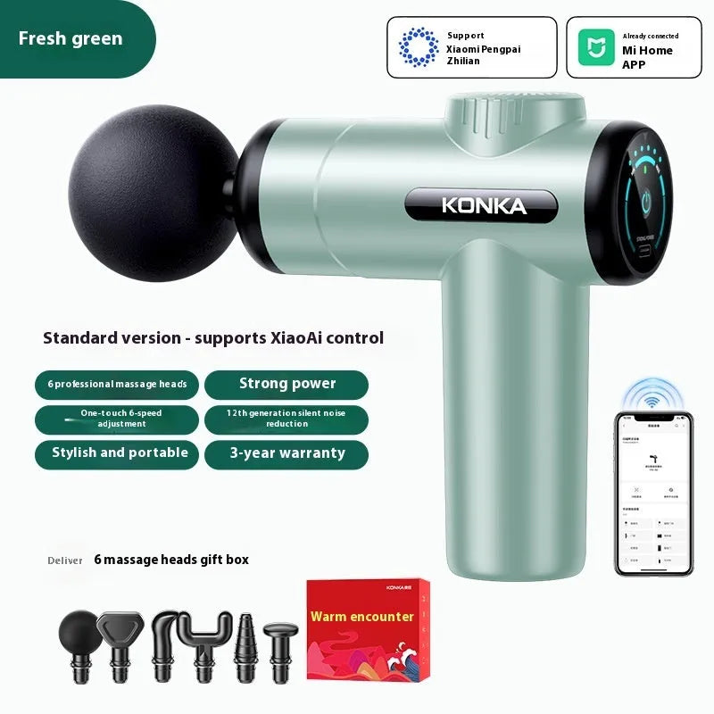 Konka professional electric mini massage gun in grey colour with multiple massage head attachments on a table.
