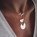 Gold multi-layer round alloy necklace with electroplated finish on white background