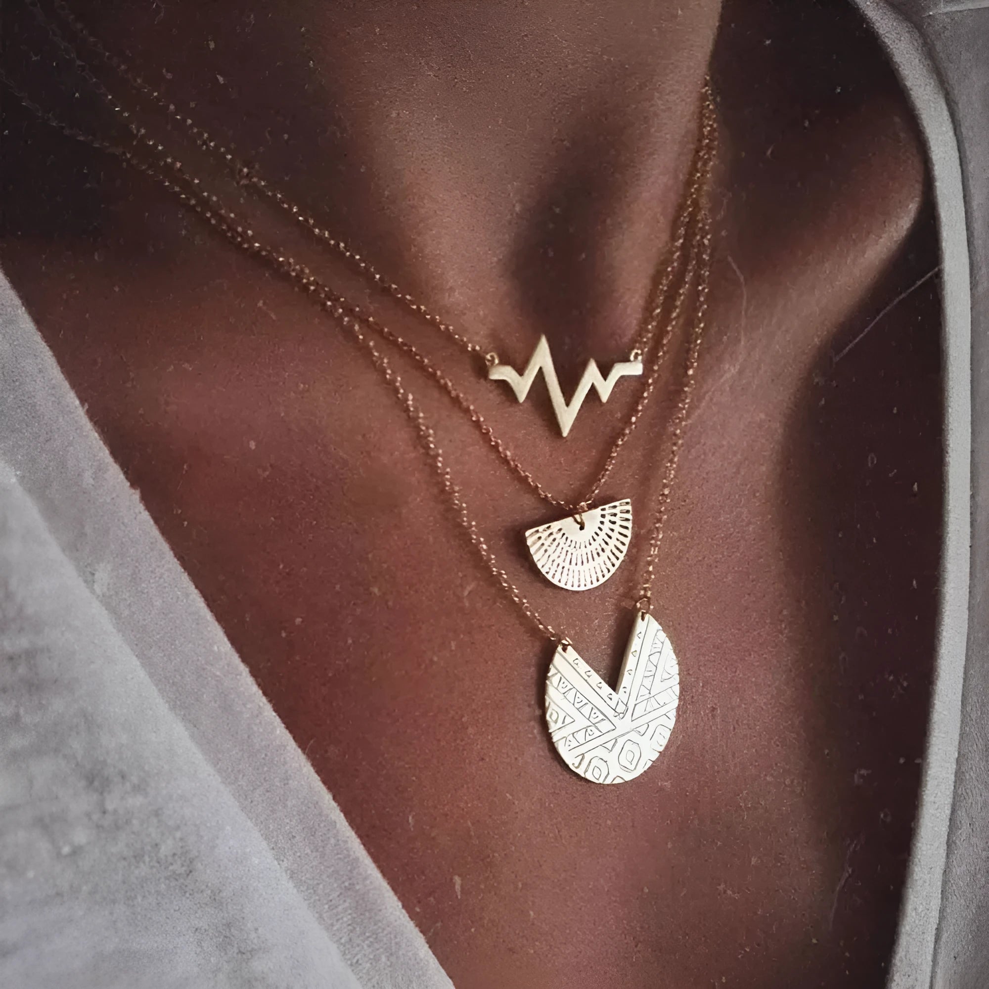 Gold multi-layer round alloy necklace with electroplated finish on white background
