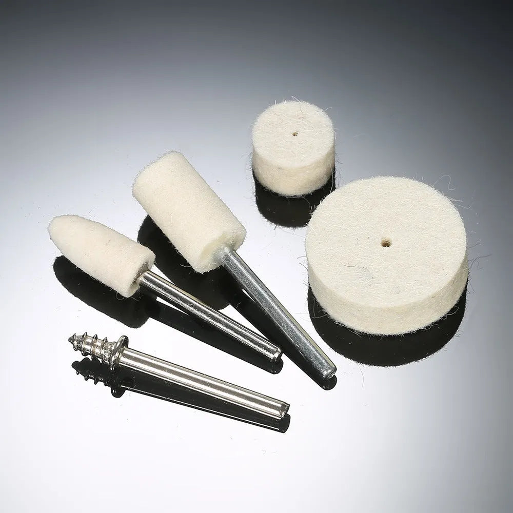 Polishing wheel accessories 129-piece set with white wool brushes and metal grinding wheels on a workbench