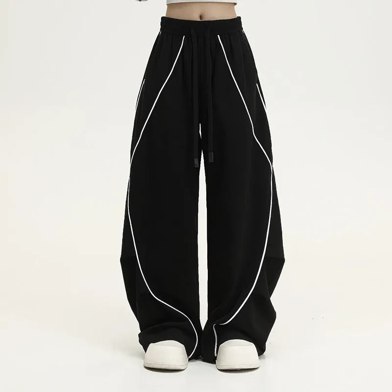 Black striped pleated hip hop wide-leg trousers with mid waist on mannequin