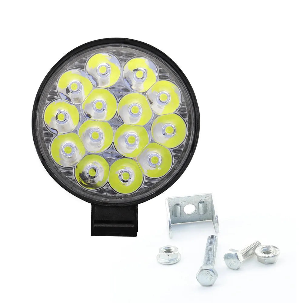 White LED mini round auxiliary work light with aluminium housing for vehicle mounting.