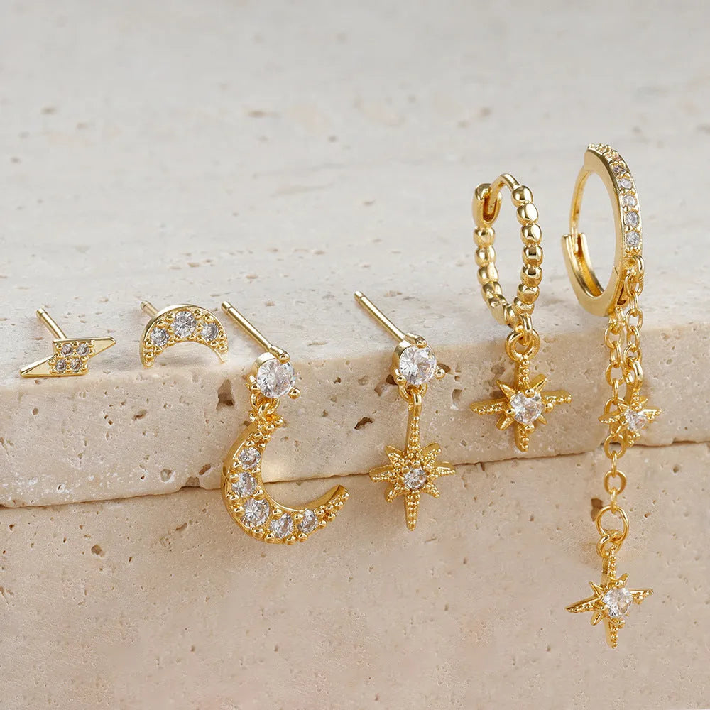 Set of six gold-coloured XINGX women's earrings with zircon studs and chain tassels.