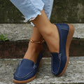 Women's black PU leather flat shoes with round toe and visible car suture stitching detail.