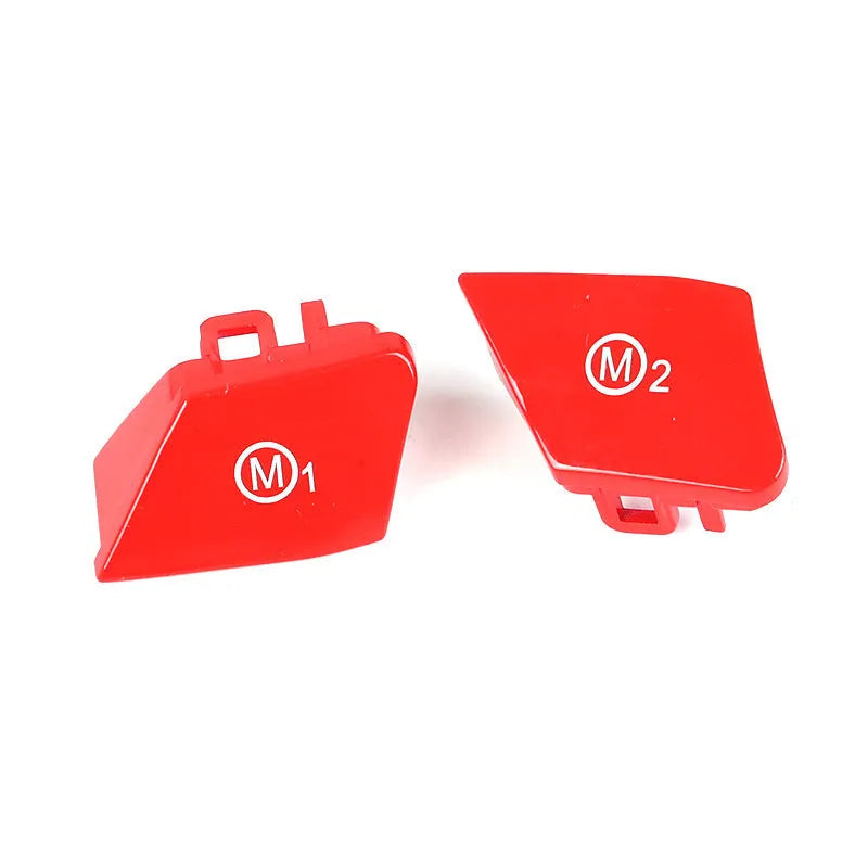 Red and blue BMW M1 M2 steering wheel button accessories with installation keys on a black background