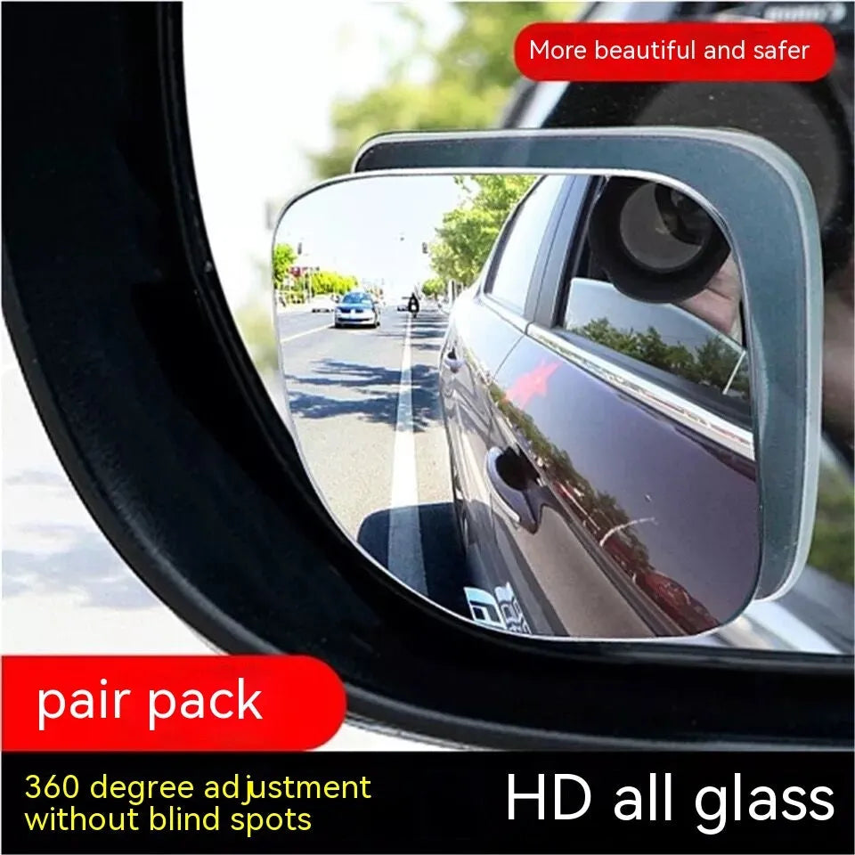 A pair of small, fan-shaped white glass blind spot mirrors for cars, showing 360-degree adjustable mounting.