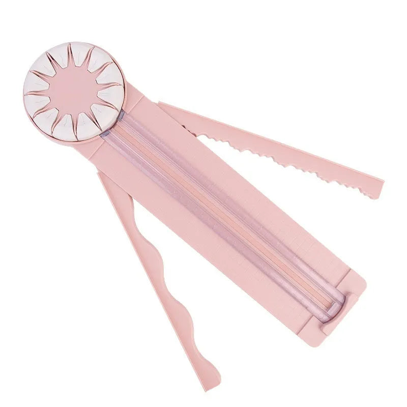 Plastic paper cutting machine with 12 patterns in pink colour on craft table