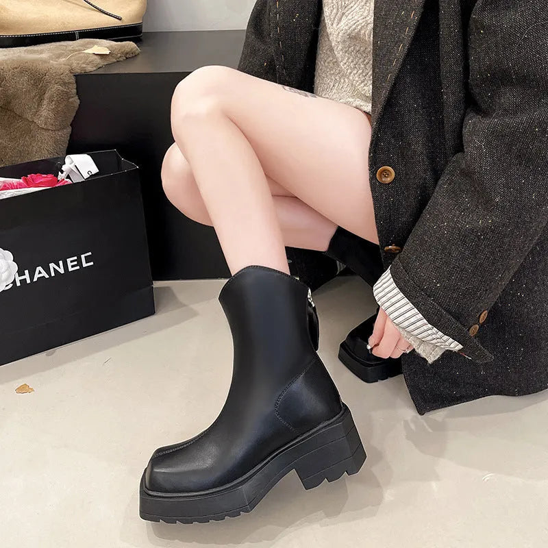 Black platform Martin boots for women with a square toe, mid calf length, and a high heel.