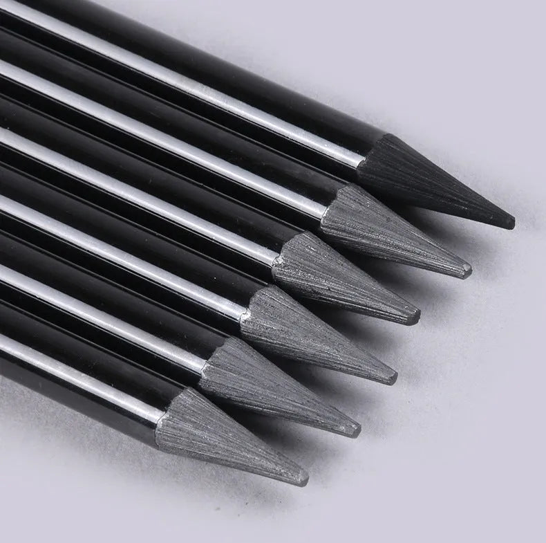 Set of six graphite and three carbonized drawing pencils with wooden casings on a suction card.