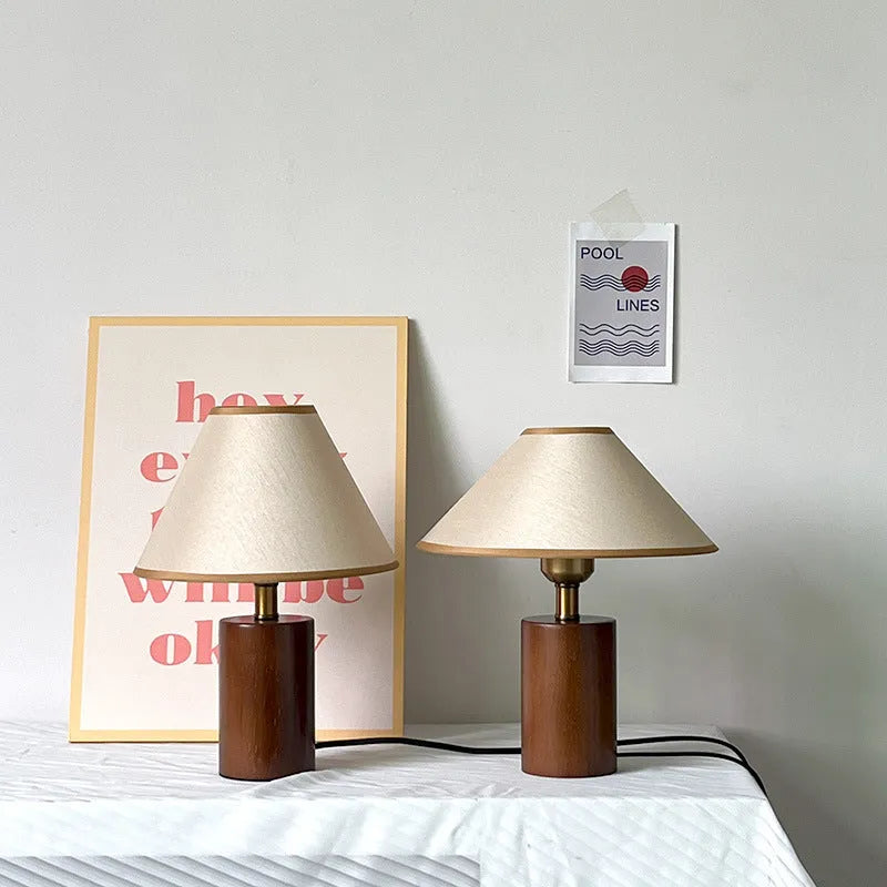 Brown cylindrical wooden bedside lamp with beige cover and E14 bulb base