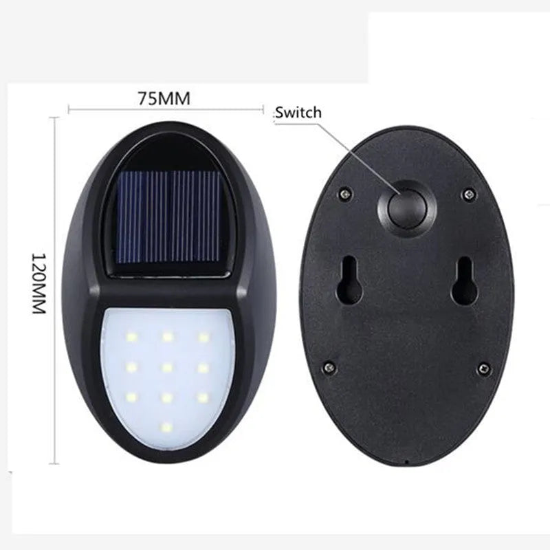 Black rectangular LED solar-powered outdoor wall light mounted on a fence.