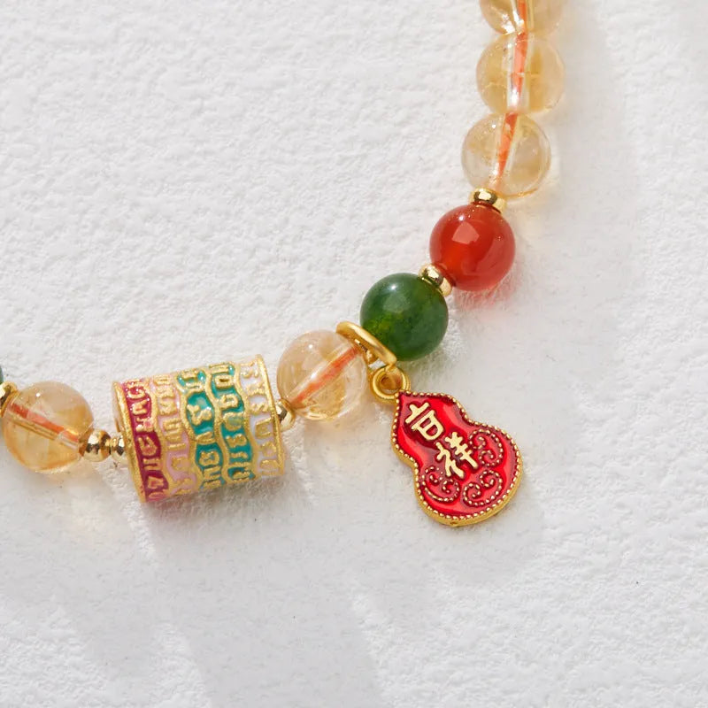 Hand-woven citrine crystal bracelet with five-sutra geometric pattern showing 6mm bead size