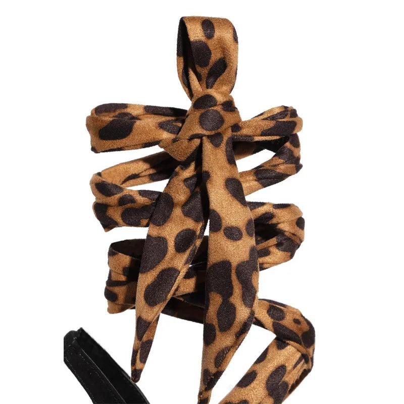 Light brown leopard print high heel sandals with Roman-style cross straps and 8cm+ heel