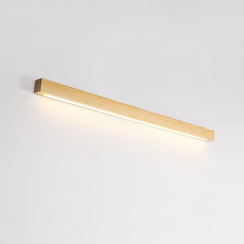 Walnut colour wood and acrylic wall lamp strip with LED lighting in a minimalist design on a wall.