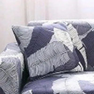 Geometric patterned stretch sofa slipcover fitted on a modern two-seater sofa.