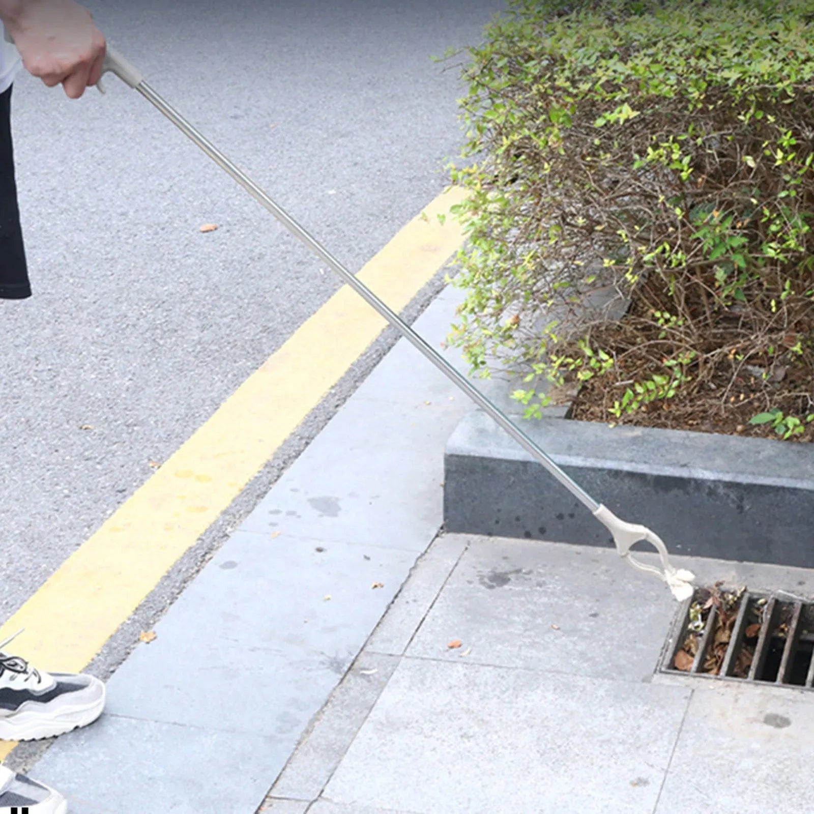 Stainless steel garbage picker with 40cm length and push-handle design for one-handed operation