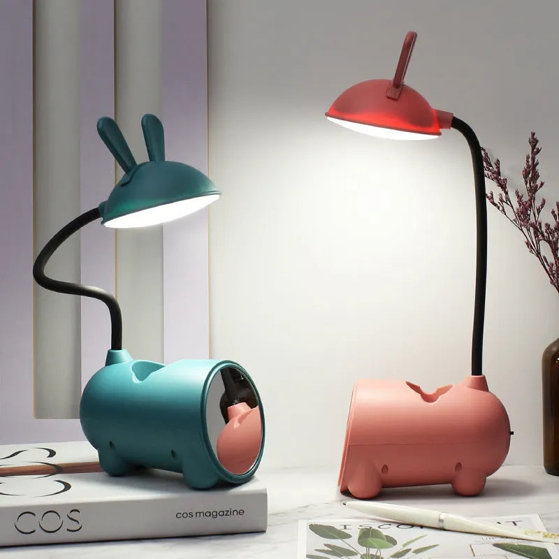 Cartoon-style USB desk lamp with integrated pen holder in green, blue, or pink colour