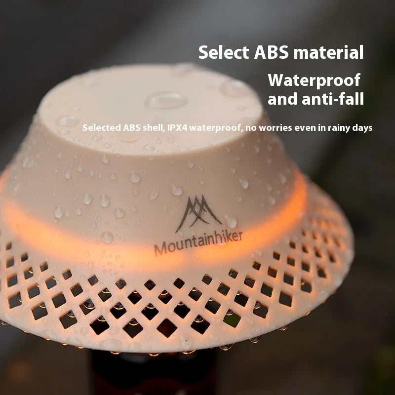 Beige wine bottle camping lantern with USB-C charging port and adjustable light modes on a wooden surface.