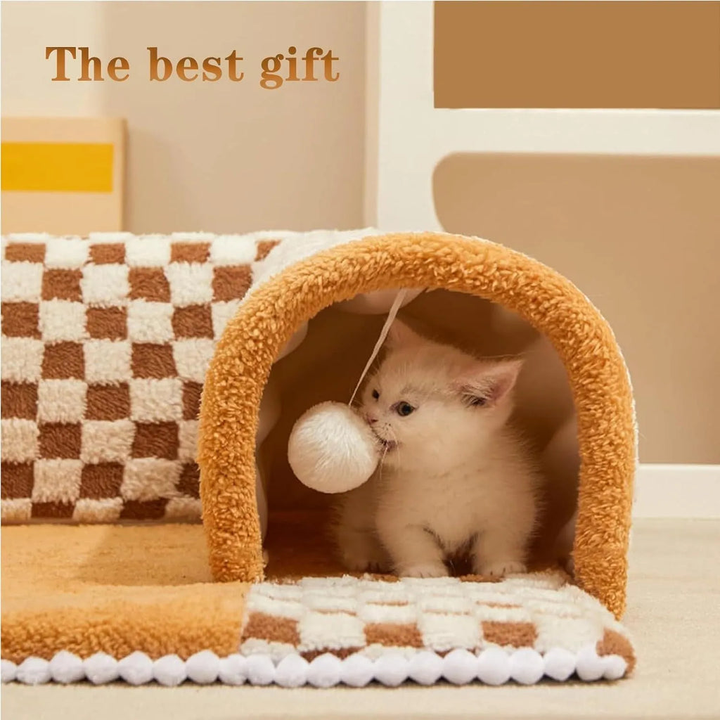 Brown plaid collapsible cat tunnel bed with a central mat on a wooden floor.