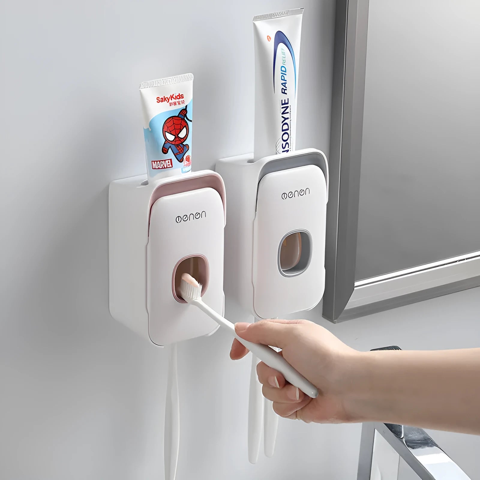 Blue automatic toothpaste dispenser made of ABS plastic on a bathroom shelf.