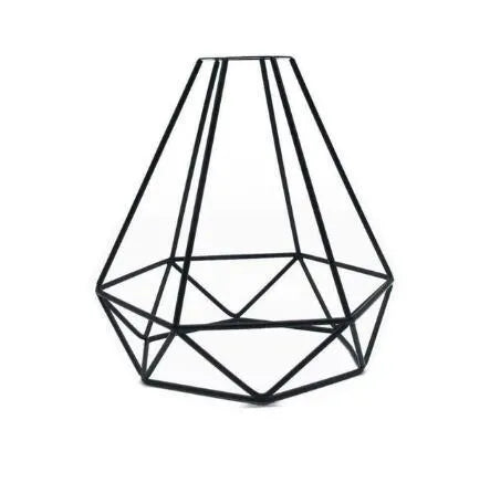 Minimalist hollow iron table lamp in red wine glass style on a wooden desk.
