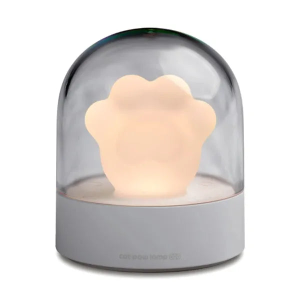 Grey cat paw USB night light with rotating illumination and music box function on wooden desk