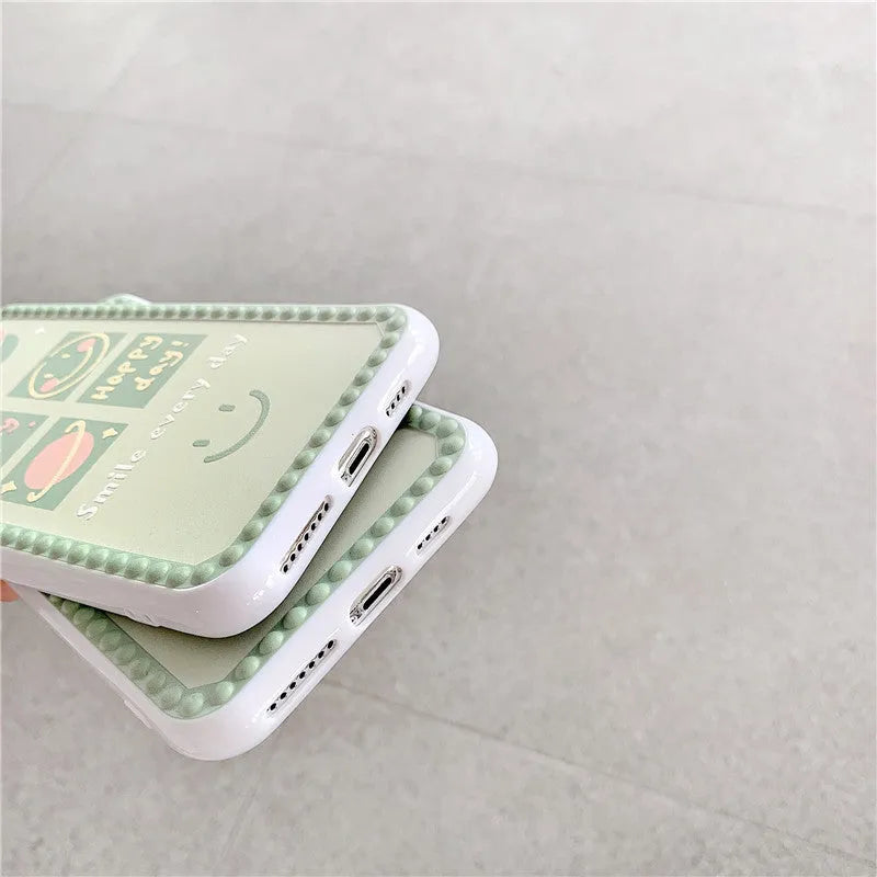 Green TPU phone case with geometric smiley face and polka dot frame design for iPhone.