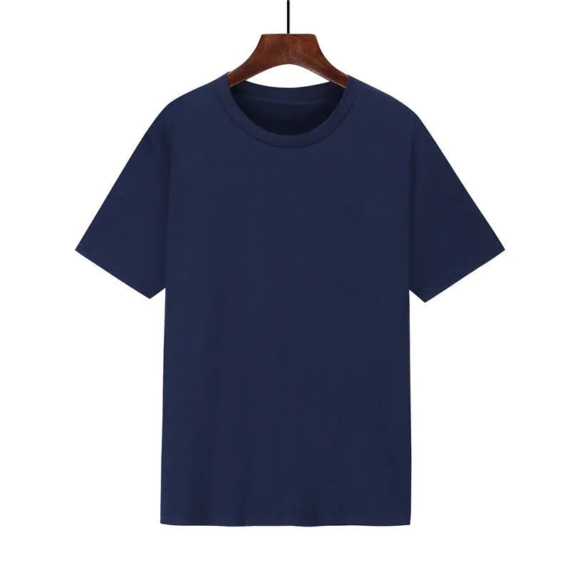 Man wearing a black loose-fit cotton T-shirt with short sleeves, showcasing casual style.