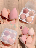 Box containing four coloured makeup egg sponges in Grape, Mango, Mint, and Peach.