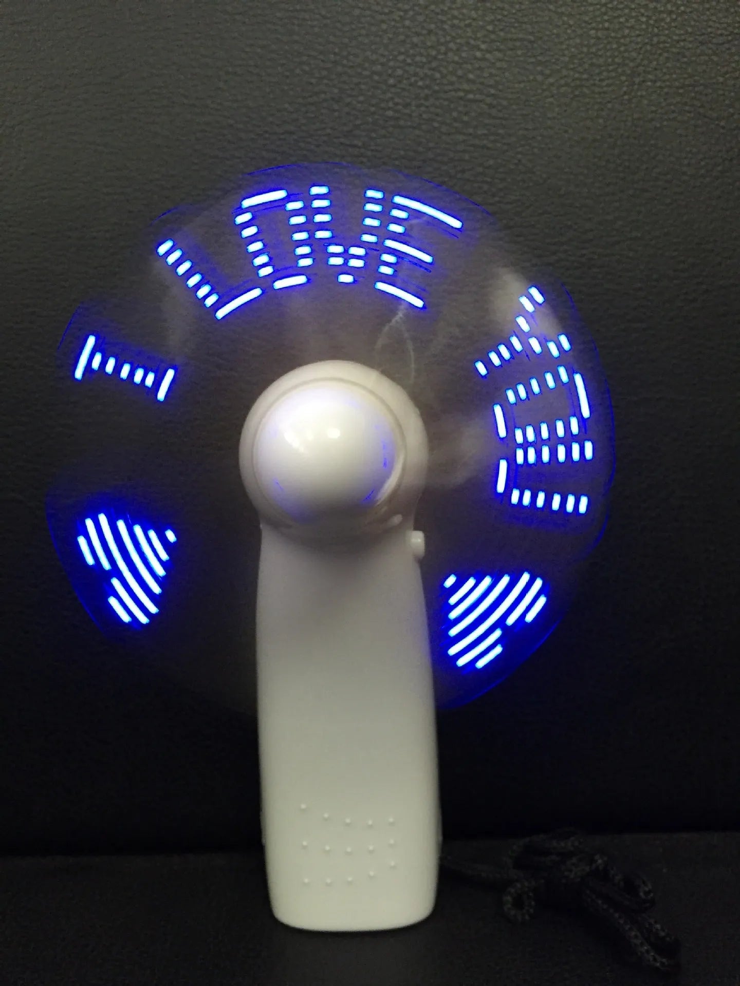 White handheld mini fan with flashing blue and red LED love pattern
