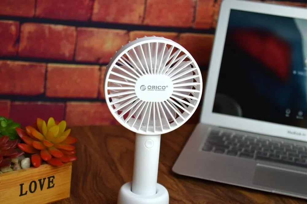 White ORICO FH1 portable USB desk fan with fine line design on a desktop.