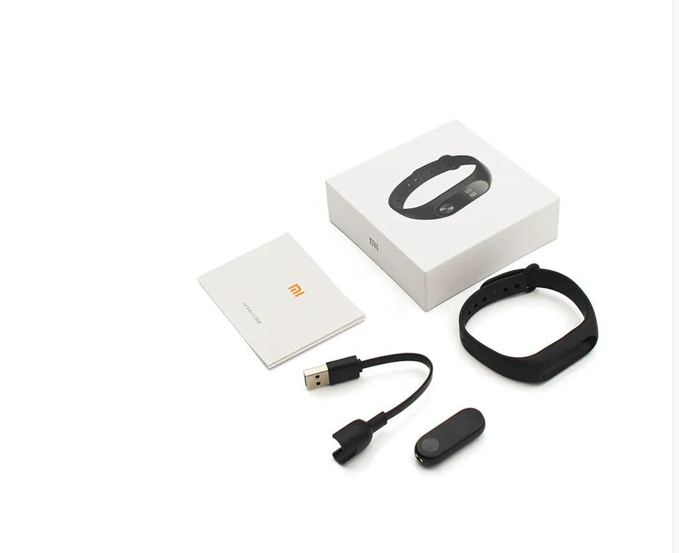 Xiaomi Mi Band 2 black fitness tracker on wrist showing OLED display