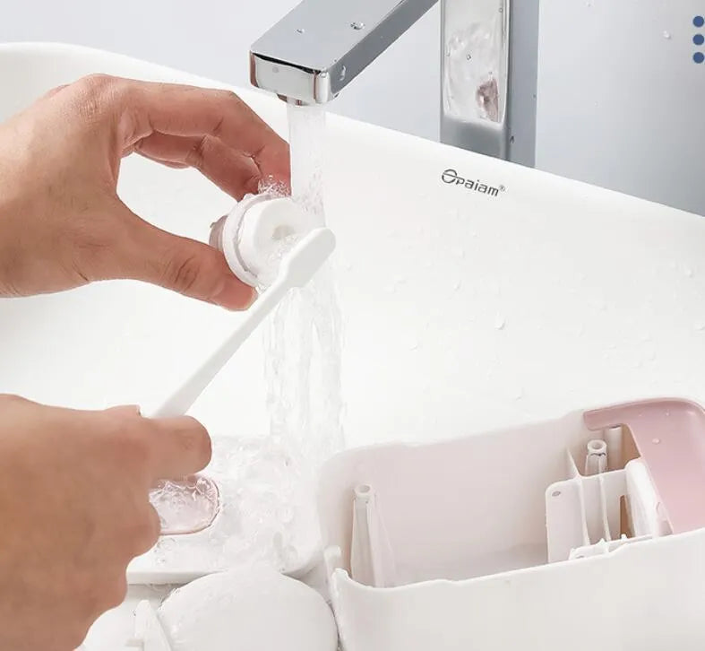 Blue automatic toothpaste dispenser made of ABS plastic on a bathroom shelf.